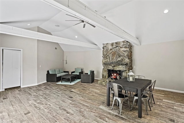 8 Hamlet Way, Hopewell Junction, NY 12533 - dining room featuring wood finished floors, a fireplace, a ceiling fan, recessed lighting, and high vaulted ceiling
