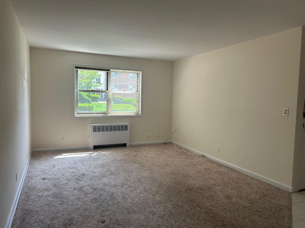 3 Cascade Ter Unit 1E, Yonkers, NY 10703 - empty room with radiator heating unit and light carpet