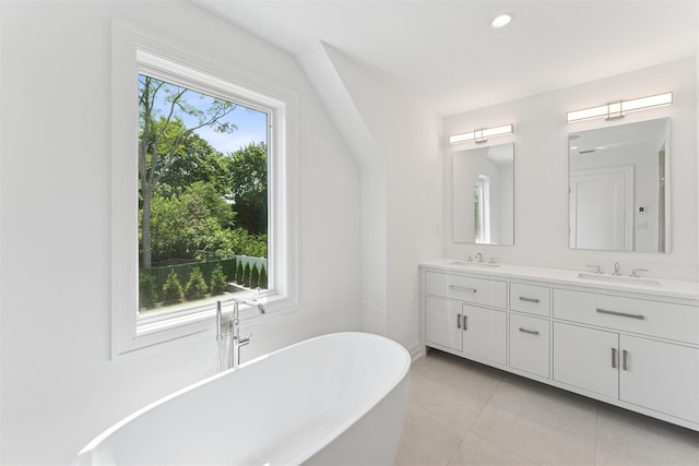 135 S Rd, Westhampton, NY 11977 - bathroom featuring double vanity, a freestanding bath, tile patterned floors, and recessed lighting
