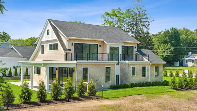 135 S Rd, Westhampton, NY 11977 - back of property featuring a balcony, a shingled roof, and a yard