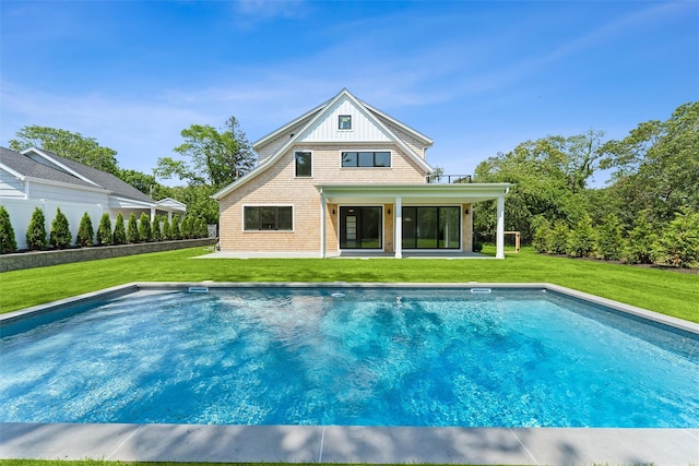 135 S Rd, Westhampton, NY 11977 - rear view of property featuring a yard, a patio, an outdoor pool, and uncovered parking