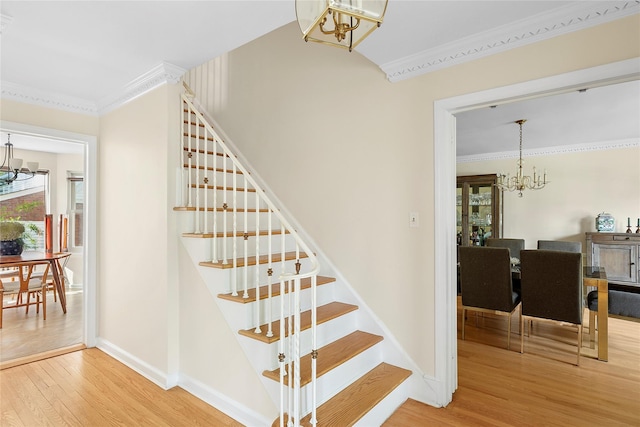 107 California Ave, Freeport, NY 11520 - stairs featuring a chandelier, ornamental molding, and wood finished floors