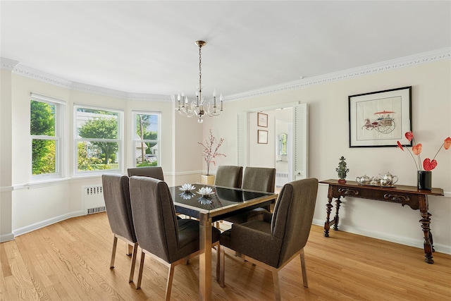 107 California Ave, Freeport, NY 11520 - dining space with radiator, a chandelier, light wood-style floors, and ornamental molding