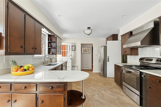 107 California Ave, Freeport, NY 11520 - kitchen with stainless steel appliances, wall chimney range hood, tasteful backsplash, radiator, and open shelves
