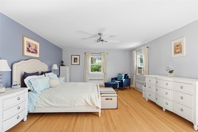 107 California Ave, Freeport, NY 11520 - bedroom featuring radiator, light wood-style flooring, and a ceiling fan