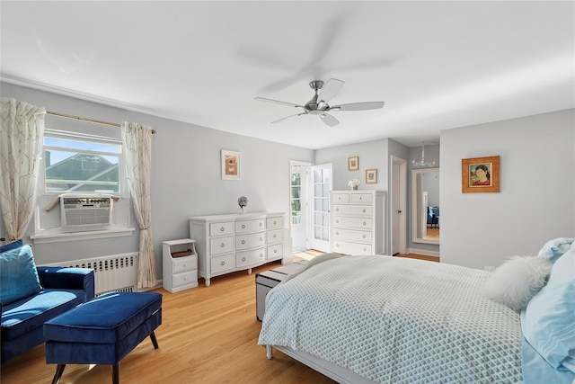 107 California Ave, Freeport, NY 11520 - bedroom featuring radiator heating unit, multiple windows, cooling unit, and light wood finished floors