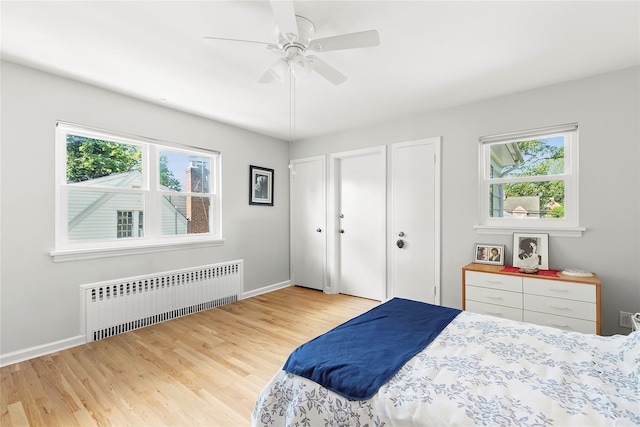 107 California Ave, Freeport, NY 11520 - bedroom with radiator heating unit, wood finished floors, and a ceiling fan