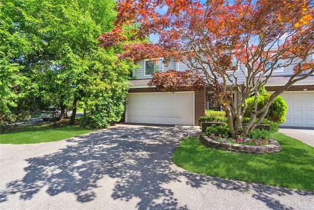 31 Boathouse Ln E, Bay Shore, NY 11706 - obstructed view of property featuring an attached garage, brick siding, and driveway