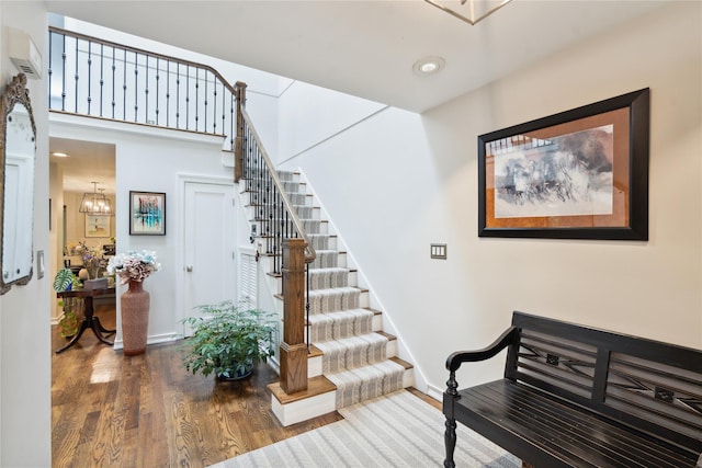 31 Boathouse Ln E, Bay Shore, NY 11706 - stairway featuring a wall mounted air conditioner, wood finished floors, and recessed lighting
