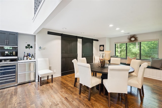 31 Boathouse Ln E, Bay Shore, NY 11706 - dining space with a barn door, wine cooler, a bar, recessed lighting, and wood finished floors