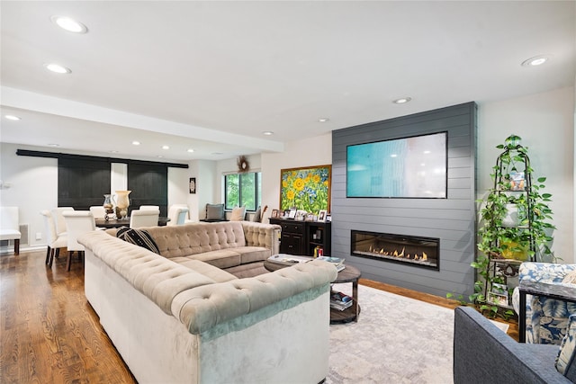 31 Boathouse Ln E, Bay Shore, NY 11706 - living area featuring a large fireplace, recessed lighting, and wood finished floors