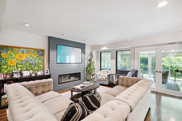 31 Boathouse Ln E, Bay Shore, NY 11706 - living room with a fireplace, french doors, plenty of natural light, wood finished floors, and recessed lighting