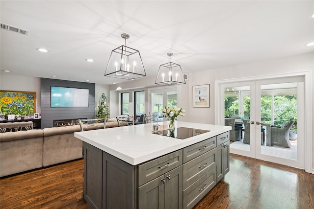 31 Boathouse Ln E, Bay Shore, NY 11706 - kitchen with french doors, gray cabinetry, light countertops, dark wood-style flooring, and healthy amount of natural light