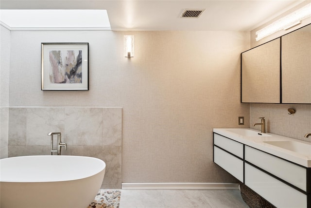 31 Boathouse Ln E, Bay Shore, NY 11706 - full bathroom featuring a freestanding tub, double vanity, and tile walls