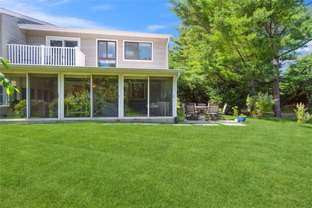 31 Boathouse Ln E, Bay Shore, NY 11706 - rear view of property featuring a sunroom, a yard, and a balcony