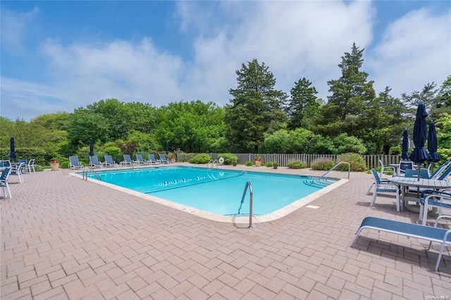 31 Boathouse Ln E, Bay Shore, NY 11706 - community pool featuring a patio and view of scattered trees
