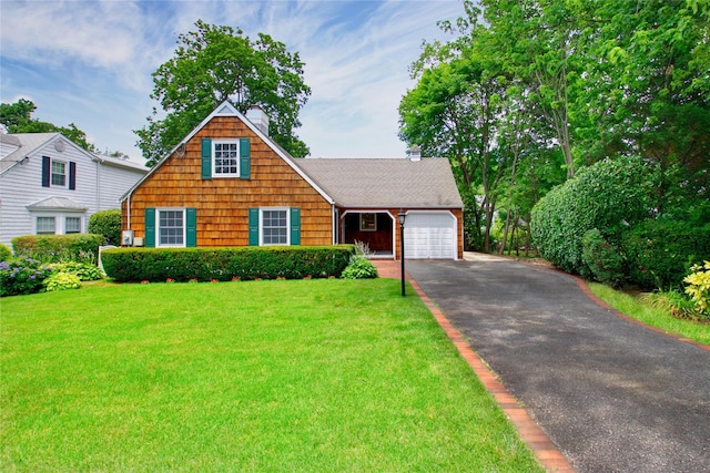 153 Park Ave, Manhasset, NY 11030 - view of front of house featuring a garage, asphalt driveway, a front lawn, and a chimney