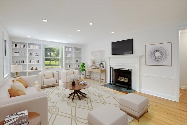 153 Park Ave, Manhasset, NY 11030 - living area with recessed lighting, wood finished floors, a fireplace with flush hearth, and built in features