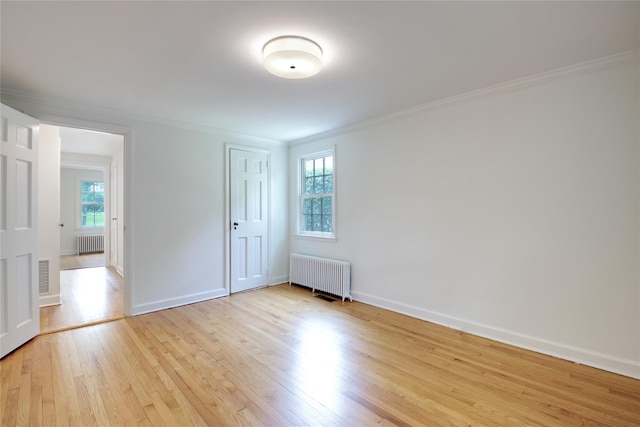 153 Park Ave, Manhasset, NY 11030 - unfurnished bedroom featuring radiator heating unit, ornamental molding, light wood-style floors, and a closet