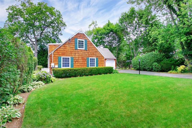 153 Park Ave, Manhasset, NY 11030 - view of front of house featuring driveway, a front yard, an attached garage, and a chimney