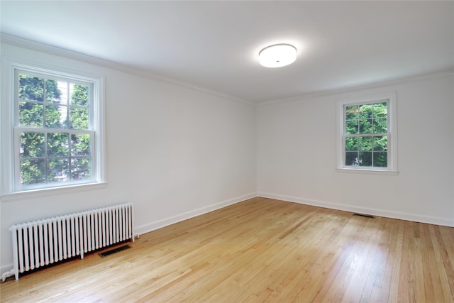 153 Park Ave, Manhasset, NY 11030 - empty room featuring radiator heating unit, hardwood / wood-style flooring, and ornamental molding