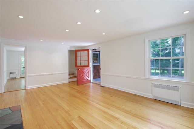 153 Park Ave, Manhasset, NY 11030 - spare room with radiator heating unit, light wood-type flooring, and recessed lighting