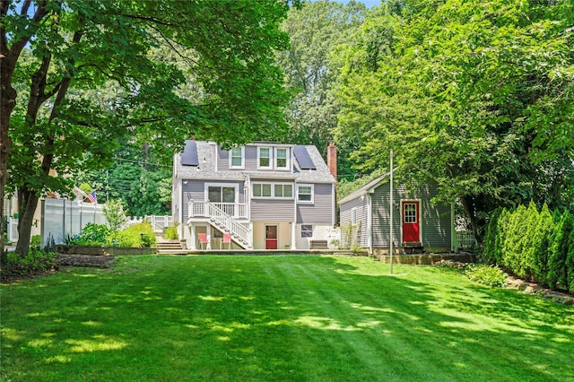 224 Woodbury Rd, Huntington, NY 11743 - back of property with stairs, a chimney, a yard, and a deck