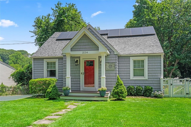 224 Woodbury Rd, Huntington, NY 11743 - bungalow-style home featuring a shingled roof, solar panels, and a gate