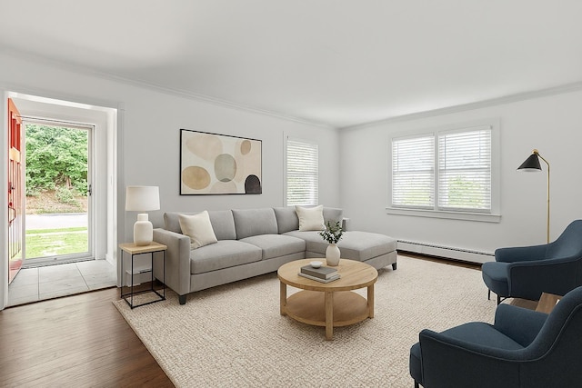 224 Woodbury Rd, Huntington, NY 11743 - living room featuring crown molding, healthy amount of natural light, a baseboard heating unit, and wood finished floors