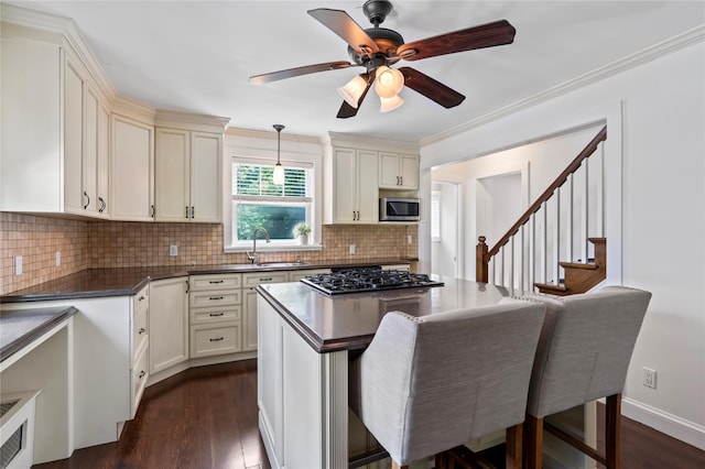 224 Woodbury Rd, Huntington, NY 11743 - kitchen with dark countertops, ceiling fan, tasteful backsplash, dark wood finished floors, and ornamental molding