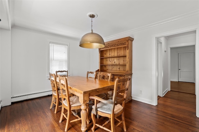 224 Woodbury Rd, Huntington, NY 11743 - dining room with wood finished floors, a baseboard heating unit, and ornamental molding