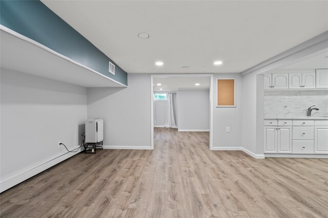 224 Woodbury Rd, Huntington, NY 11743 - below grade area with light wood-type flooring and recessed lighting