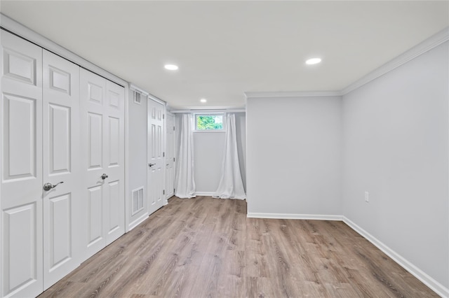 224 Woodbury Rd, Huntington, NY 11743 - below grade area featuring wood finished floors, ornamental molding, and recessed lighting
