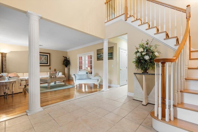 2 Apple Ct, Eastchester, NY 10709 - tiled foyer entrance featuring decorative columns, crown molding, stairway, and a high ceiling