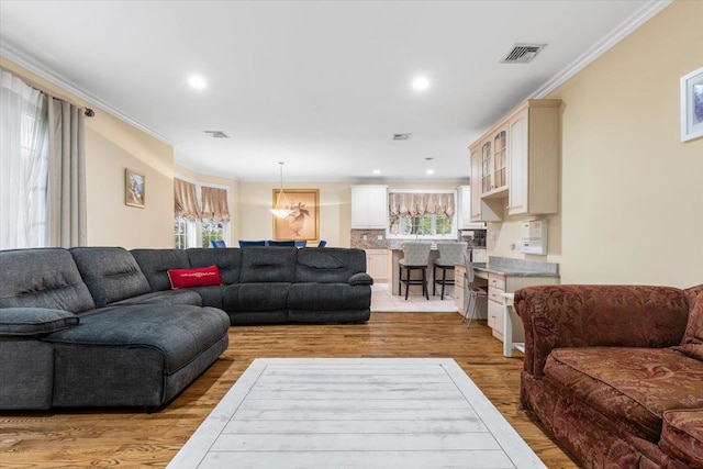 2 Apple Ct, Eastchester, NY 10709 - living room with light wood finished floors, ornamental molding, and recessed lighting