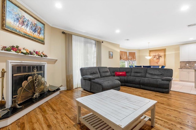 2 Apple Ct, Eastchester, NY 10709 - living room featuring light wood-style floors, crown molding, recessed lighting, and a fireplace with raised hearth