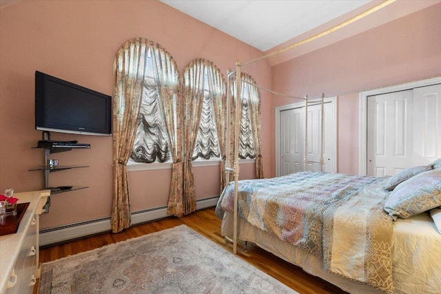 2 Apple Ct, Eastchester, NY 10709 - bedroom featuring lofted ceiling, multiple closets, wood finished floors, and a baseboard radiator