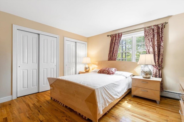 2 Apple Ct, Eastchester, NY 10709 - bedroom featuring multiple closets, light wood finished floors, and a baseboard radiator