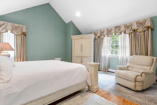 2 Apple Ct, Eastchester, NY 10709 - bedroom with a baseboard heating unit, wood finished floors, and lofted ceiling