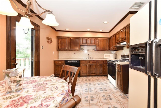7 Albergo Ln, Syosset, NY 11791 - kitchen with white appliances, under cabinet range hood, light countertops, ornamental molding, and backsplash