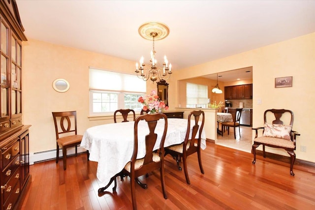 7 Albergo Ln, Syosset, NY 11791 - dining room featuring a chandelier, dark wood-type flooring, and a baseboard heating unit
