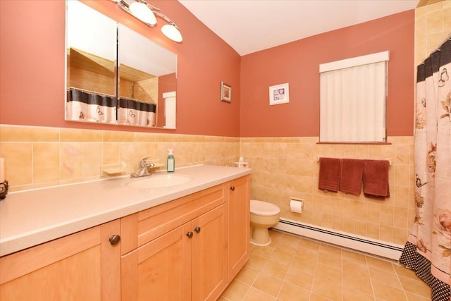 7 Albergo Ln, Syosset, NY 11791 - bathroom featuring baseboard heating, vanity, tile walls, a wainscoted wall, and tile patterned flooring