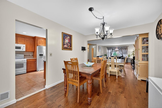 418 Pawnee Ct, Suffern, NY 10901 - dining space with a chandelier and light wood-style floors