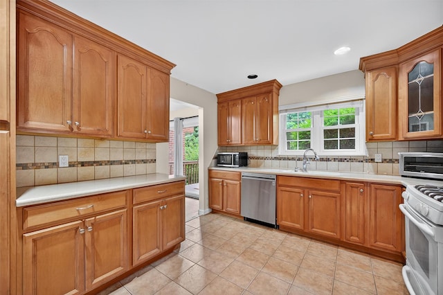 418 Pawnee Ct, Suffern, NY 10901 - kitchen featuring dishwasher, light countertops, backsplash, white range oven, and light tile patterned flooring
