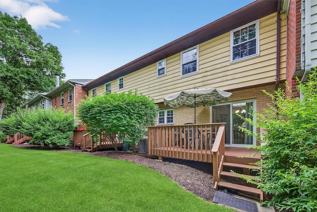 418 Pawnee Ct, Suffern, NY 10901 - rear view of house featuring a wooden deck, a yard, and brick siding