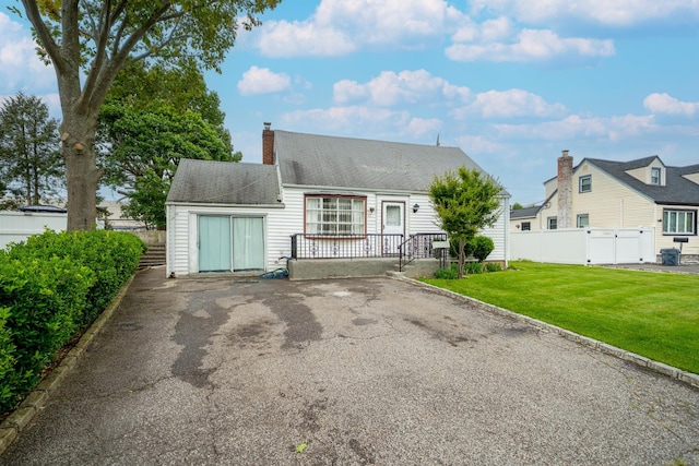 47 Cardinal Rd, Levittown, NY 11756 - cape cod house featuring a chimney and a shingled roof