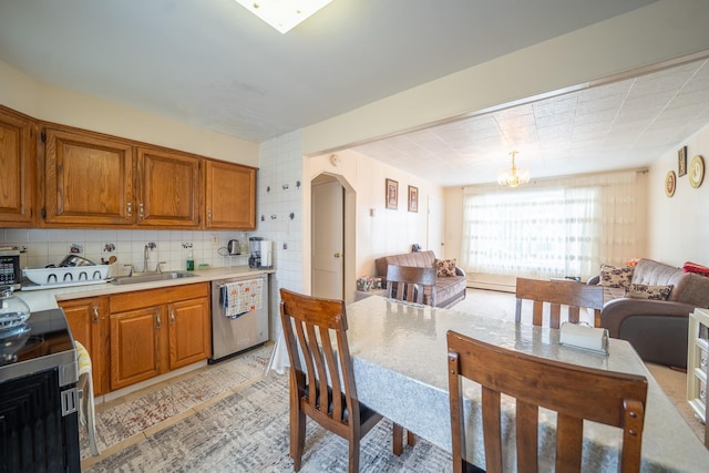 47 Cardinal Rd, Levittown, NY 11756 - kitchen featuring dishwasher, range, brown cabinets, and light countertops