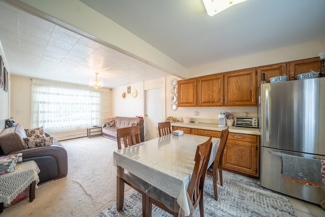 47 Cardinal Rd, Levittown, NY 11756 - kitchen featuring freestanding refrigerator, brown cabinets, light countertops, a chandelier, and open floor plan