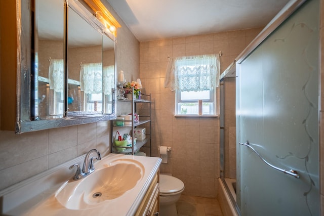 47 Cardinal Rd, Levittown, NY 11756 - full bathroom featuring tile walls, vanity, shower / bath combination with glass door, and tile patterned floors