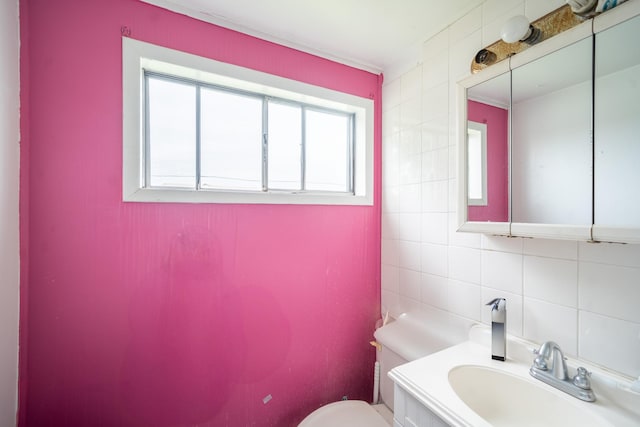 47 Cardinal Rd, Levittown, NY 11756 - bathroom with tile walls, vanity, and tasteful backsplash